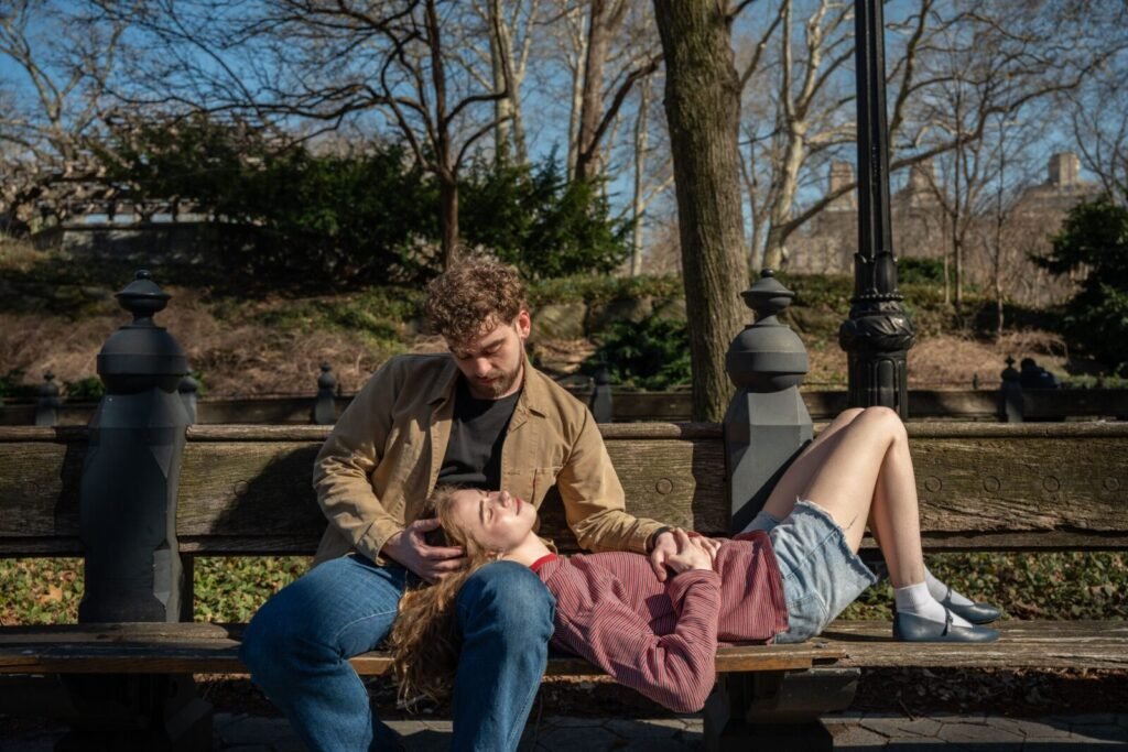 A young couple enjoying a peaceful moment on a sunny day in Central Park, New York City.
